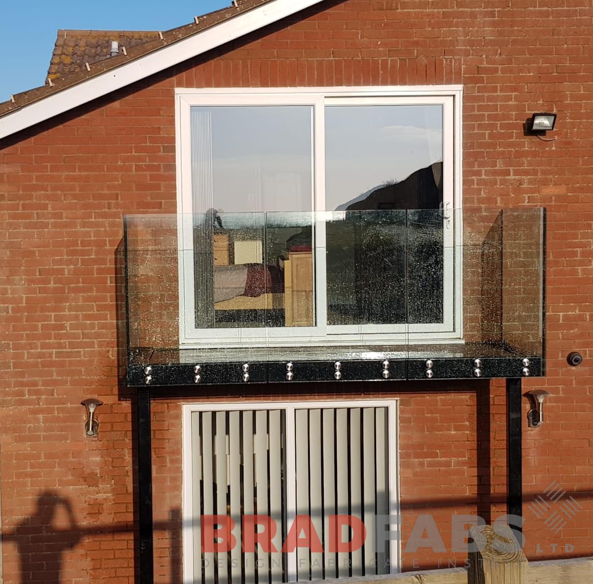 Beautiful baclony with two support legs and very popular front face fixed infinity glass balustrade by Bradfabs 
