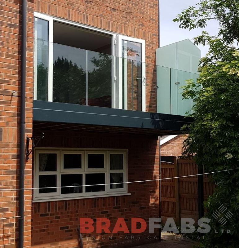 Beautiful home addition, mild steel, galvanised and powder coated balcony with infinity glass balustrade and privacy screen to one side by Bradfabs 