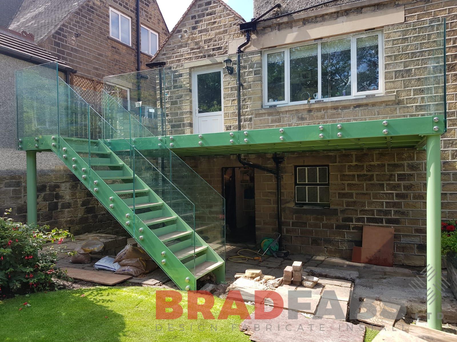 Mild steel, galvanised and powder coated balcony with bolt on infinity glass balustrade and straight staircase by Bradfabs 