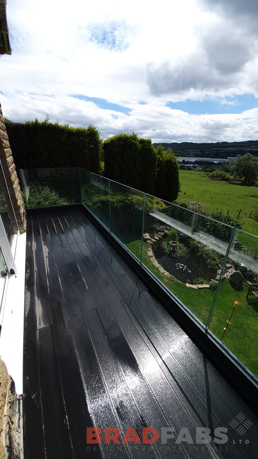 Bespoke balcony with one supporting leg and channel system infinity glass by Bradfabs Ltd 