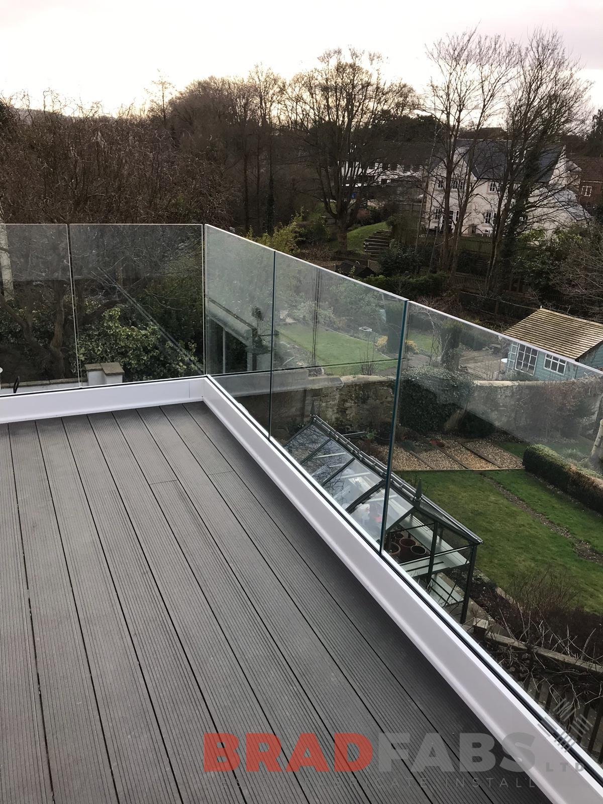 Stunning balcony with infinity glass balustrade and composite decked flooring, in mild steel, galvanised and powder coated by Bradfabs 