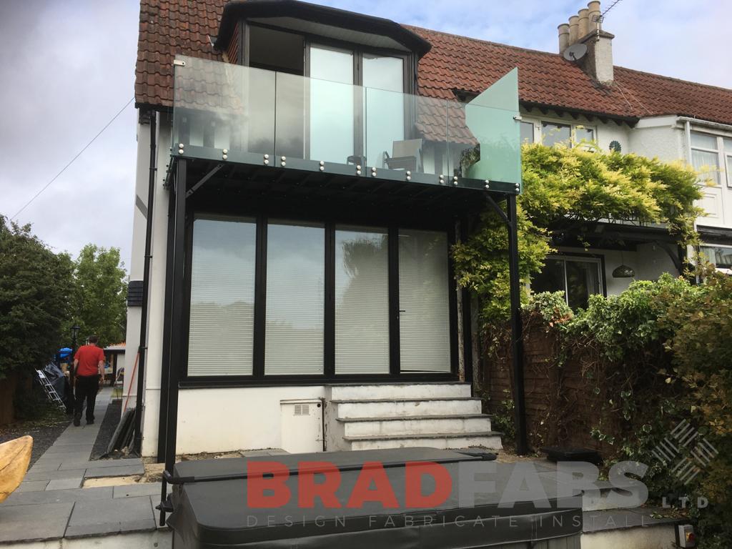 Balcony with bolt on infinity glass balustrade and privacy screen to one side by Bradfabs Ltd 