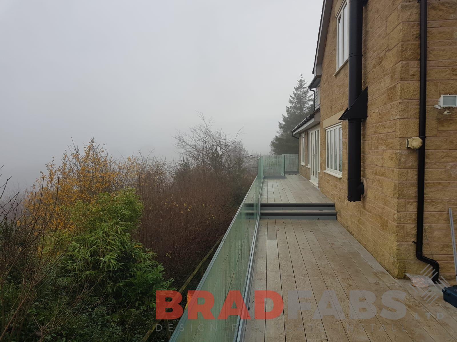 Beautiful modern balcony with infinity galss balustrade and milboard decking by Bradfabs UK LTD 