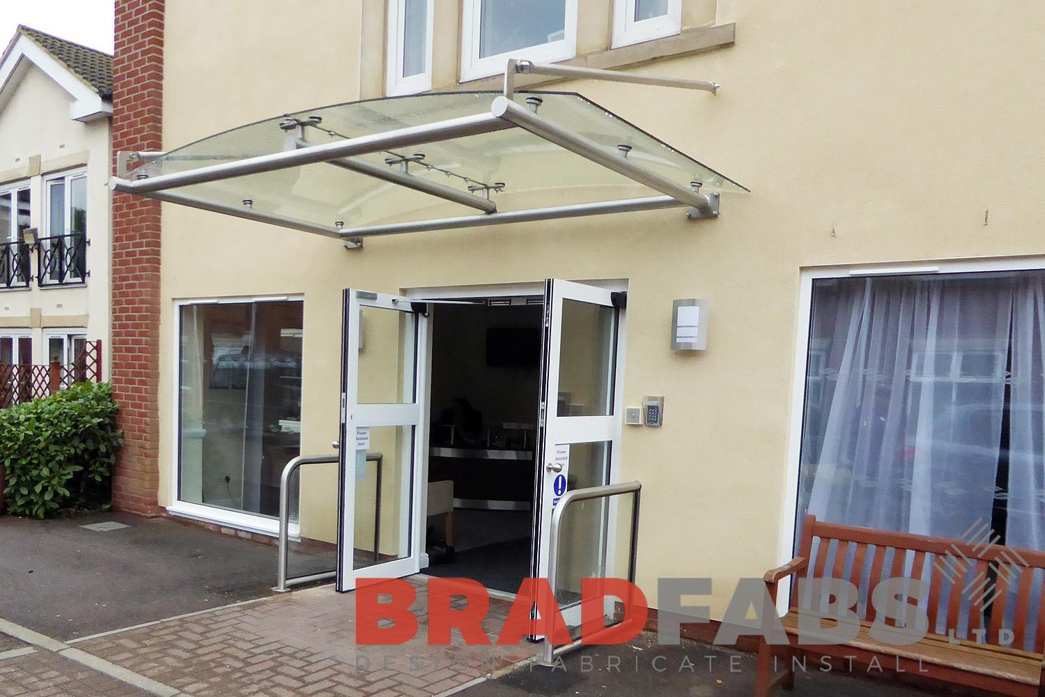 curved glass and steel panel canopy in an entrance installed for nursing home