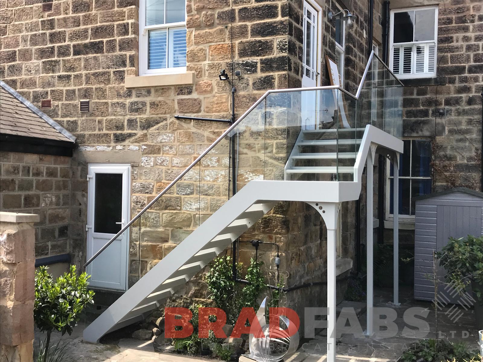 Access Staircase in mild steel, galvanised and powder coated with glass balustrade