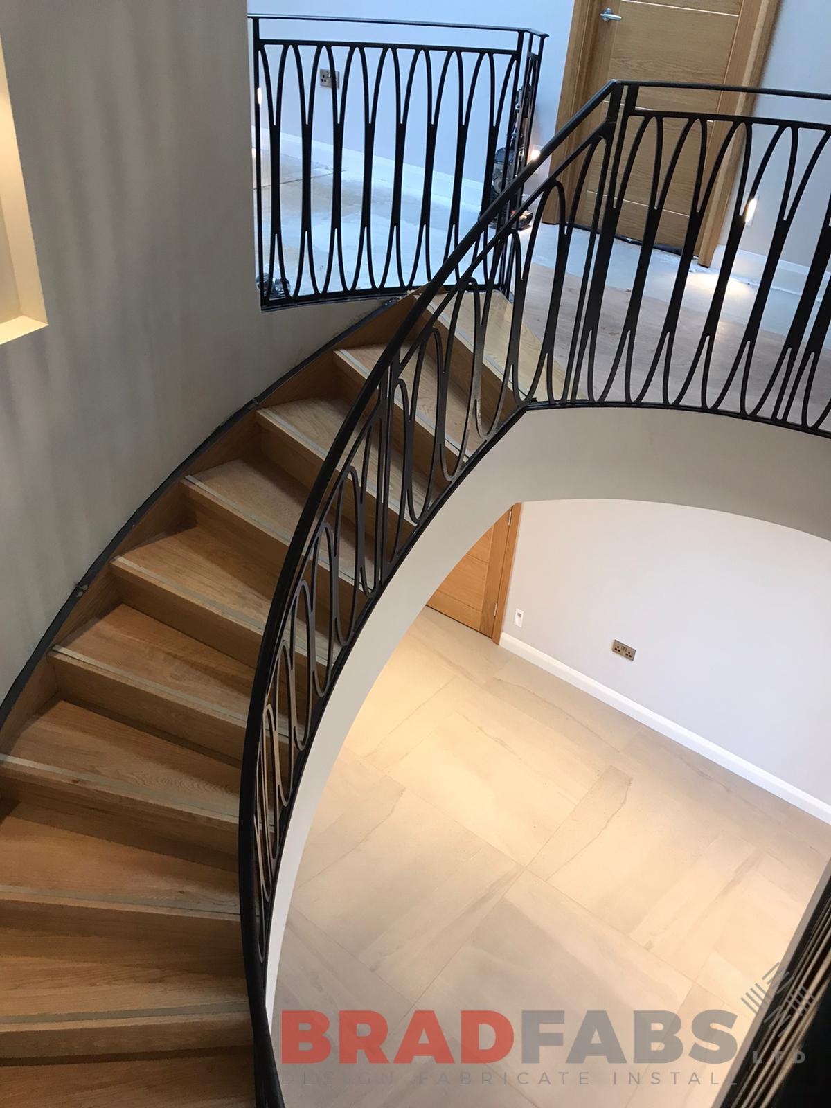  Bespoke helical staircase, oak treads with stainless steel insert and veneer stringer, laser cut feature balustrade by Bradfabs Ltd 