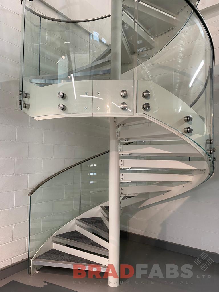Spiral staircase, curved glass balustrade and stainless steel top rail, bespoke steel fabrication, Bradfabs 