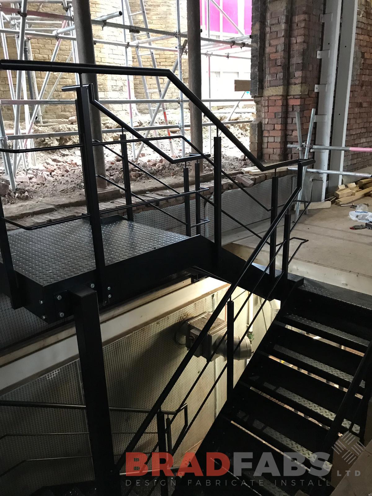 Mild steel, powder coated black straight staircase in a commercial property with durbar treads by Bradfabs 