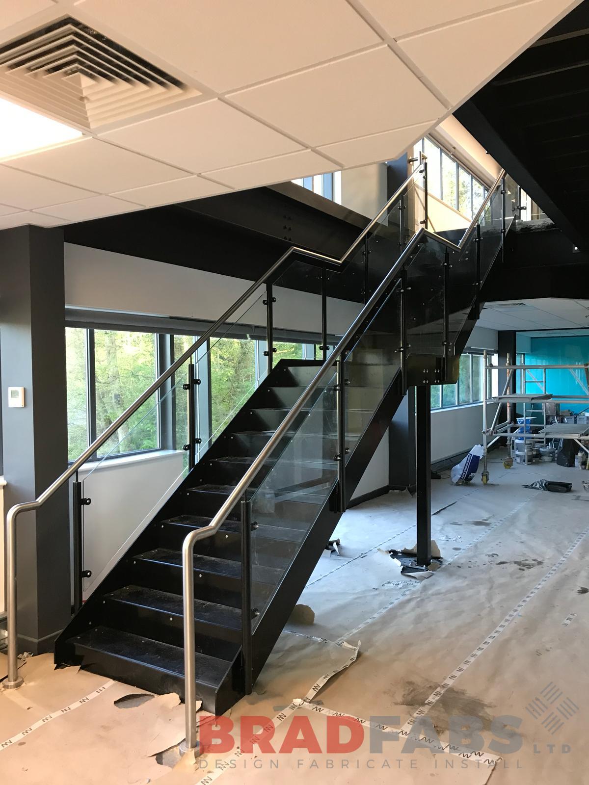 Straight staircase mild steel and powder coated with 10mm toughened safety glass infill panels and stainless steel handrail by Bradfabs
