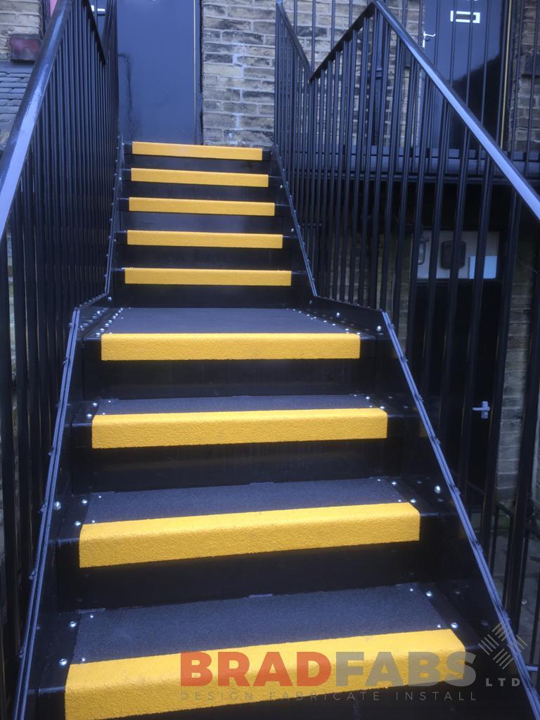 mild steel, galvanised and powder coated external staircase with yellow nosings on the treads by Bradfabs Ltd 